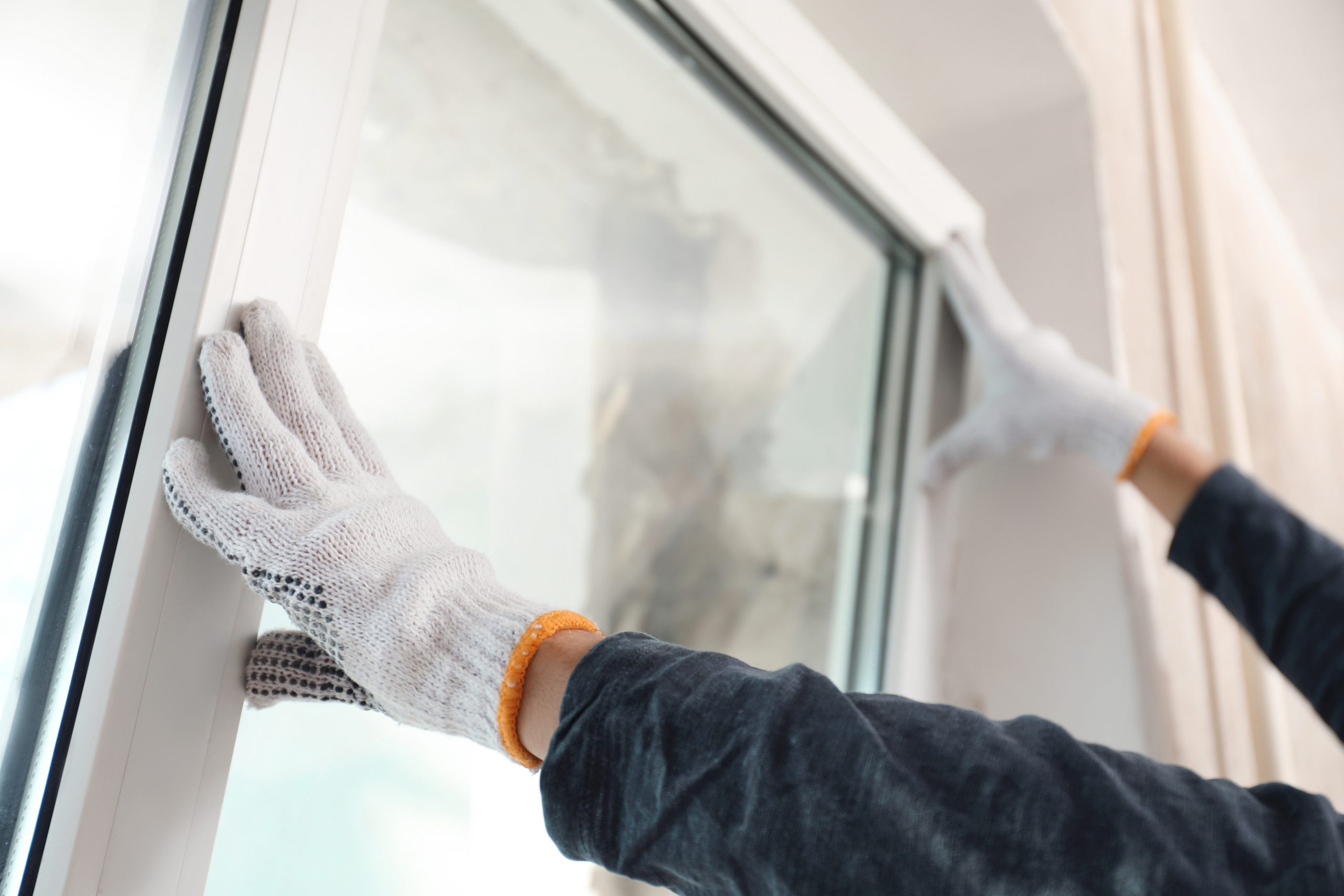 Window installer fitting a new energy-efficient replacement window